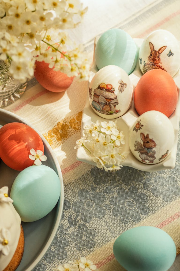 Stylish Easter table with colorful decorated eggs and spring flowers.